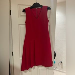 Red sleeveless pleated dress